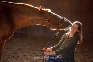 Photo of a horse kissing a woman