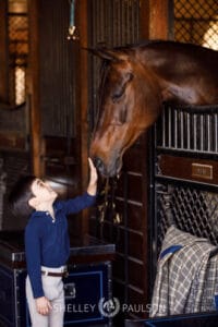 Photo of a boy petting a horse