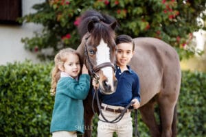 portrait of two kids and their pony