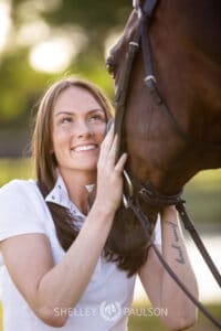 Portrait of a woman looking at her horse